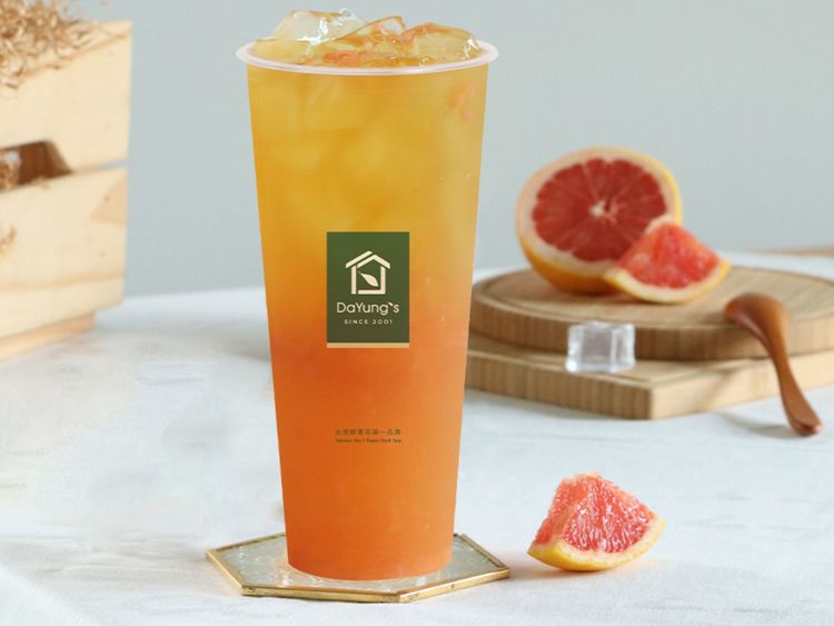 Grapefruit Green Tea with ruby grapefruit pulp, grapefruit halves beside it